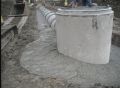 Concrete bedding around drop inlet riser.