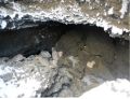 Piping void above outlet conduit near spillway tower.