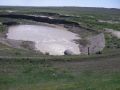 This photo shows the same apron as the previous photo. The erosion evident downstream would have progressed to the toe of dam without the apron.