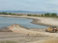 Judith Basin County, Montana Dam. 55 feet high, 6000 acre-feet. The project rehabilitated an old bituminous coated CMP pipe by replacing the downstream portion with RCP pipe and sliplining the upstream portion with CIPP. Photo: Building upstream cofferdam.