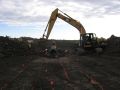 Excavating pipe trench.