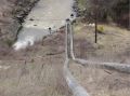 Discharge pipes running down dam embankment