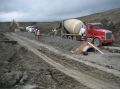 Installed pipe with concrete bedding and cap.